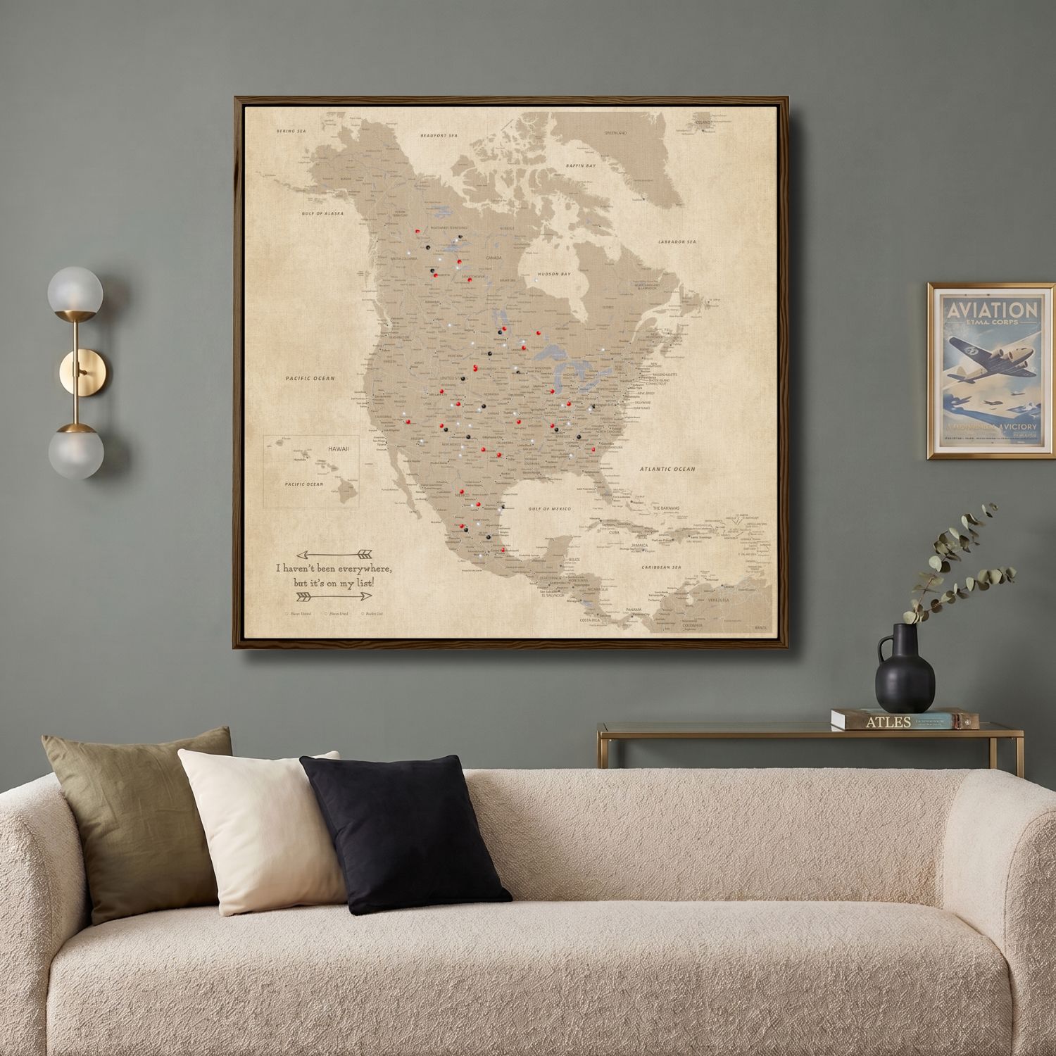 Vintage North America travel map canvas with pins displayed above modern living room sofa