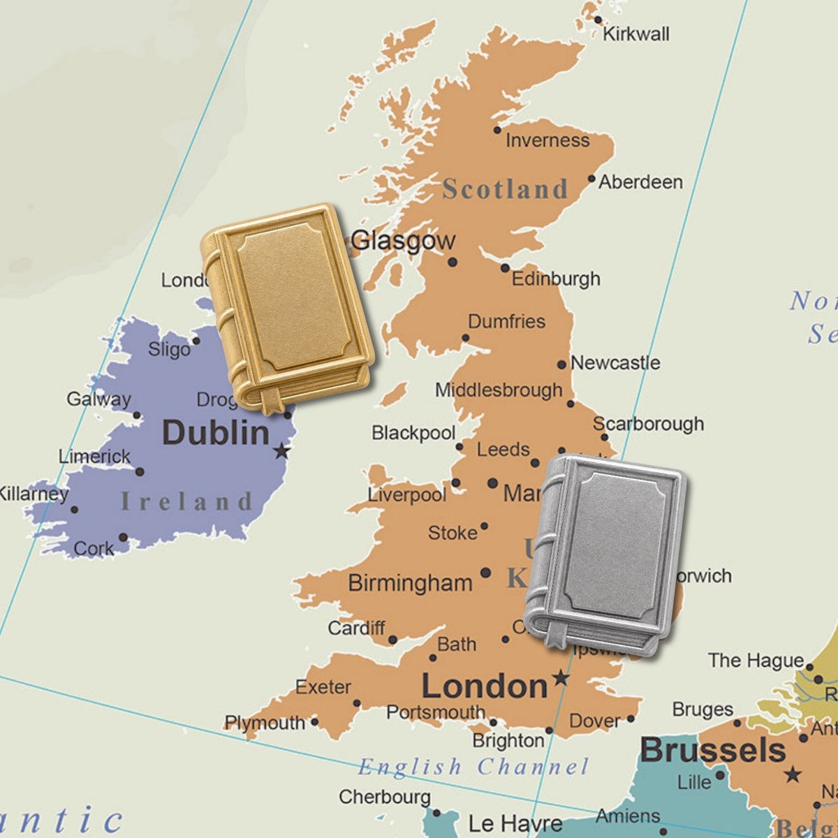 Gold and silver 3D metal book push pins displayed on UK and Ireland map