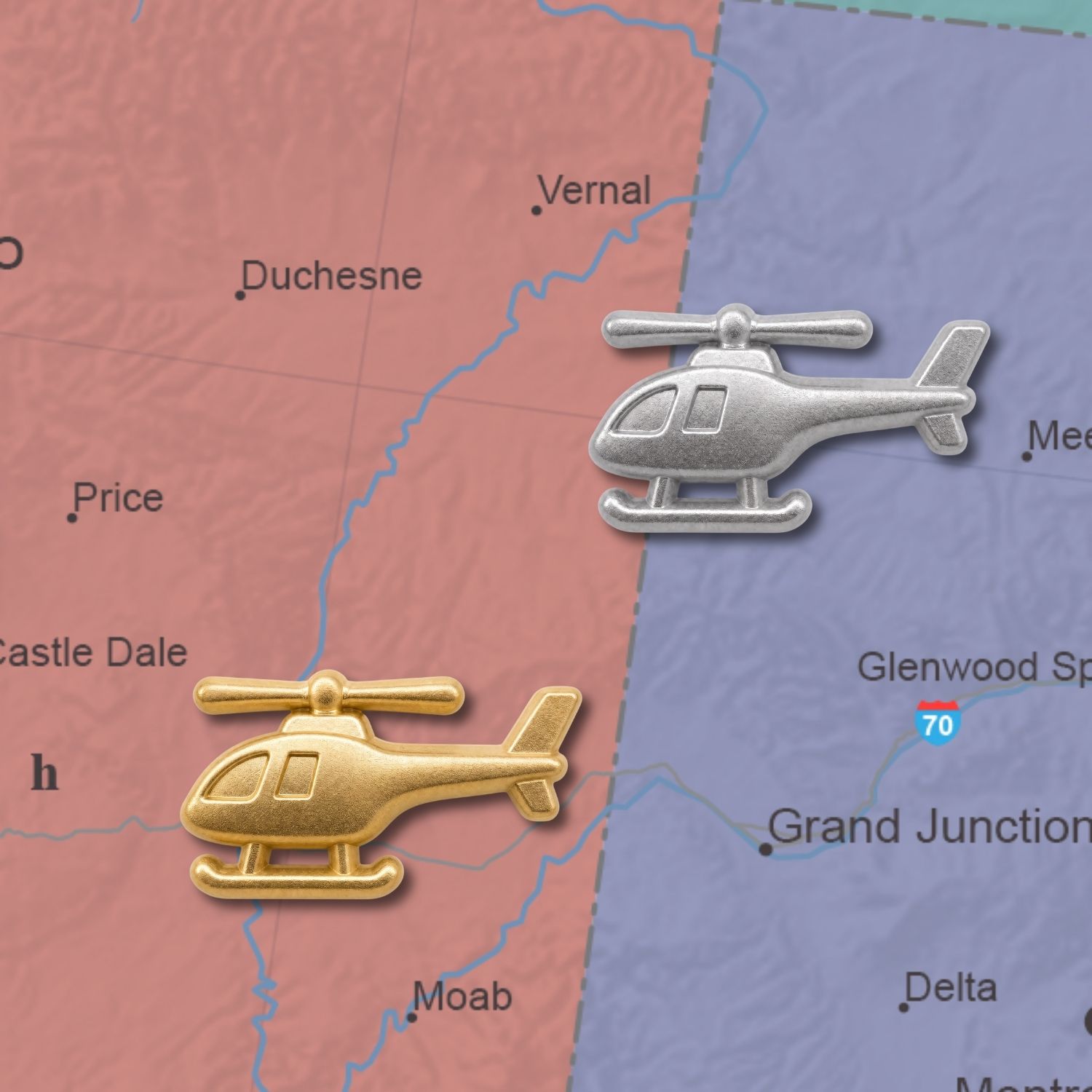 Gold and silver 3D metal helicopter push pins placed on a colorful road map