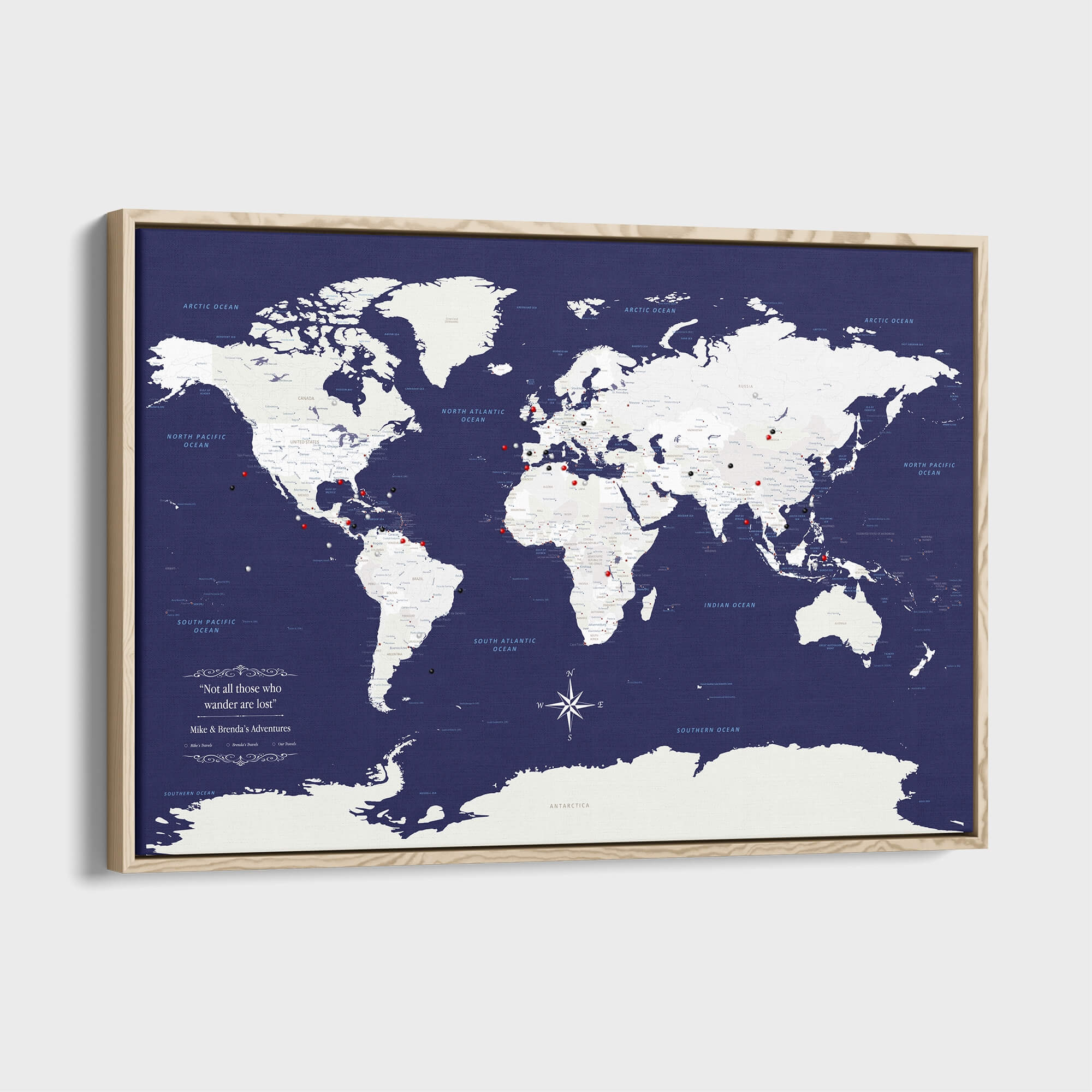 Navy Explorers world travel map canvas with push pins in natural wood frame angled view