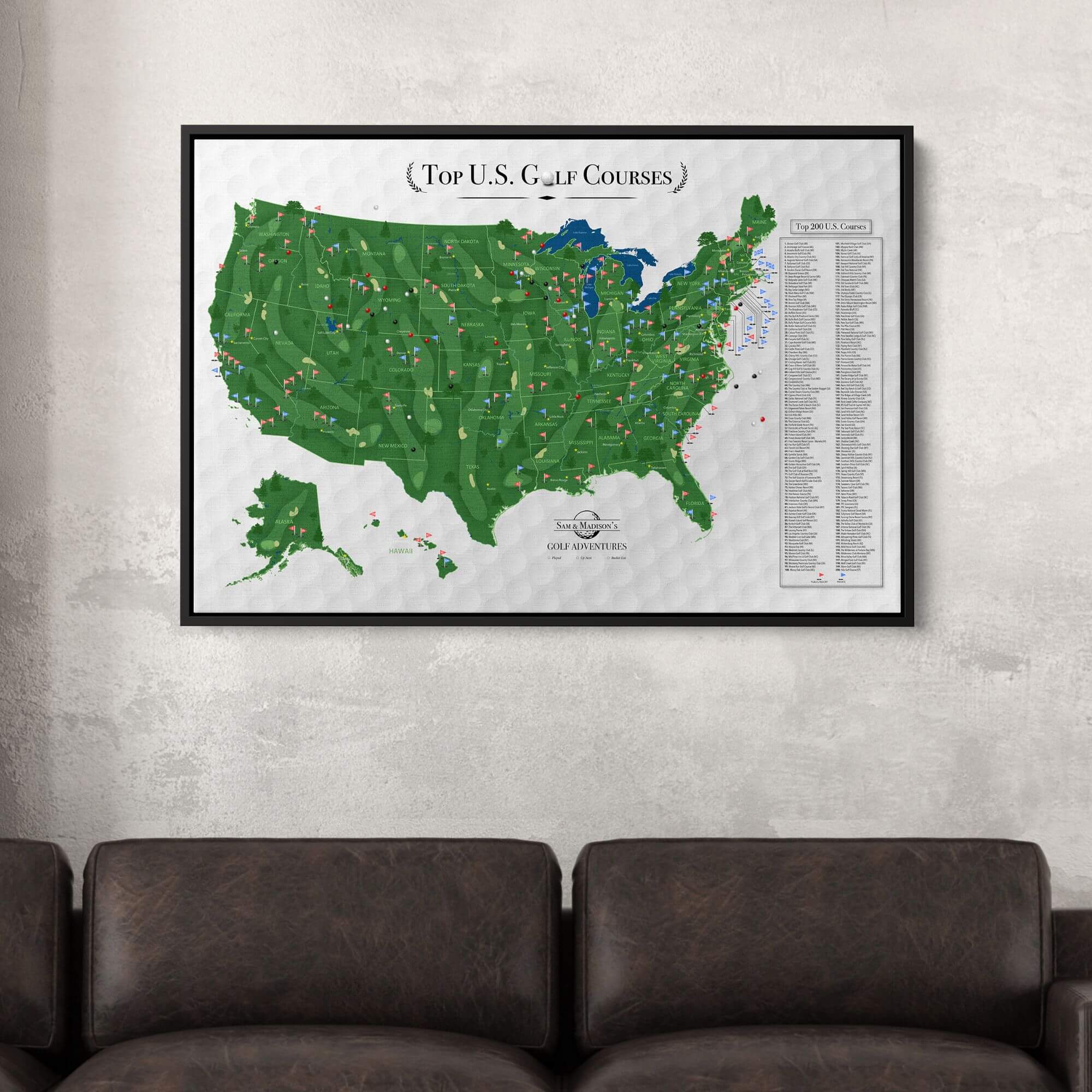 Framed canvas Top US Golf Courses travel map with pins displayed above dark leather sofa