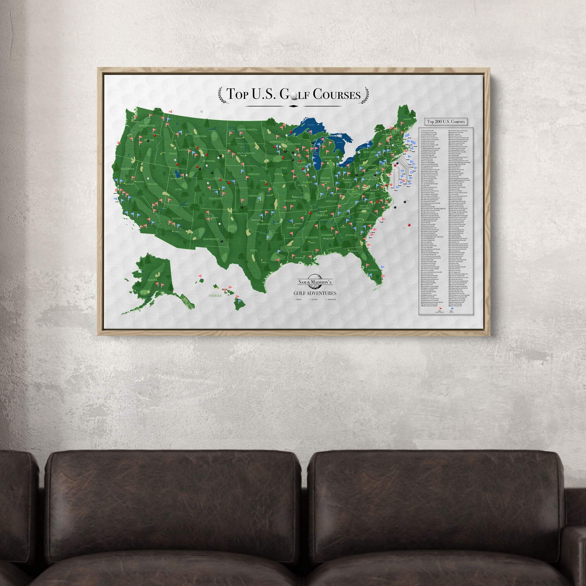 Personalized Top US Golf Courses canvas map with pins displayed in wood frame above leather sofa