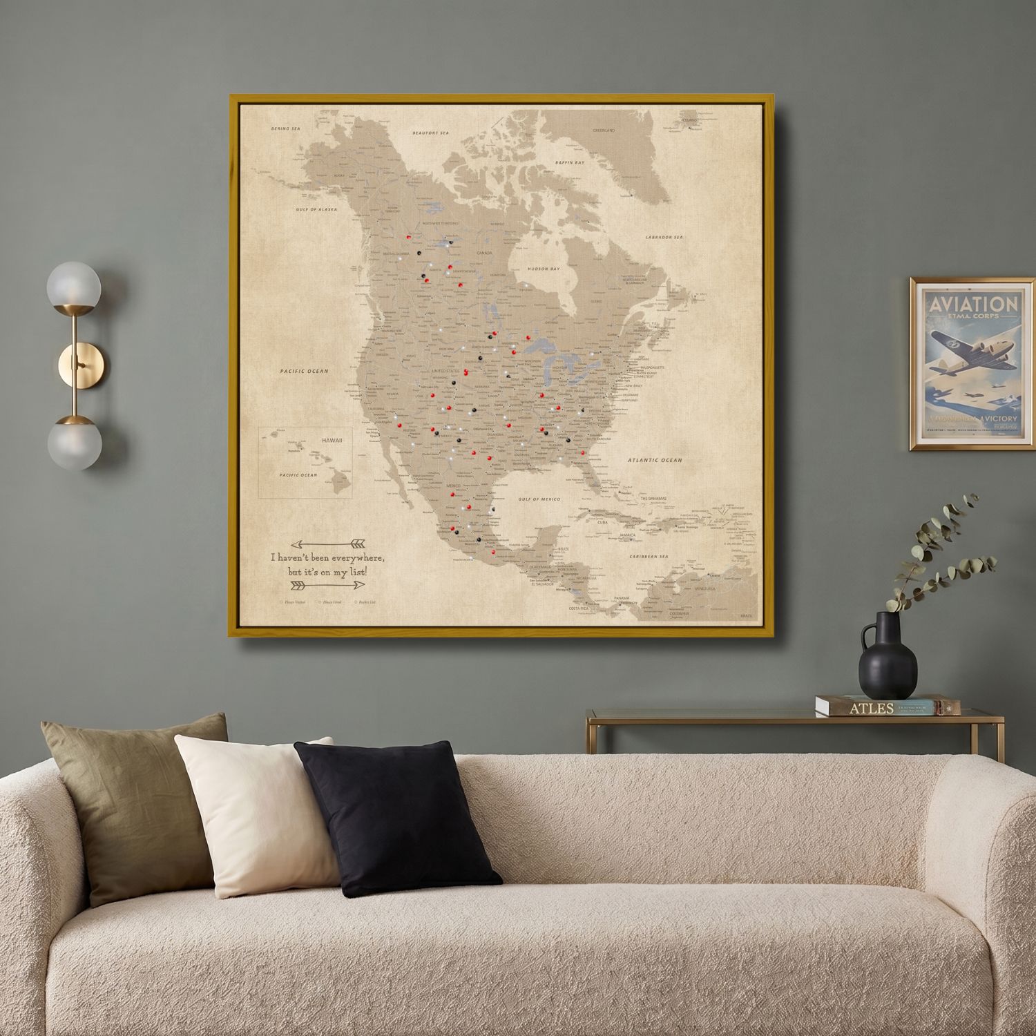 Vintage North America travel map canvas with gold frame hanging above modern living room sofa