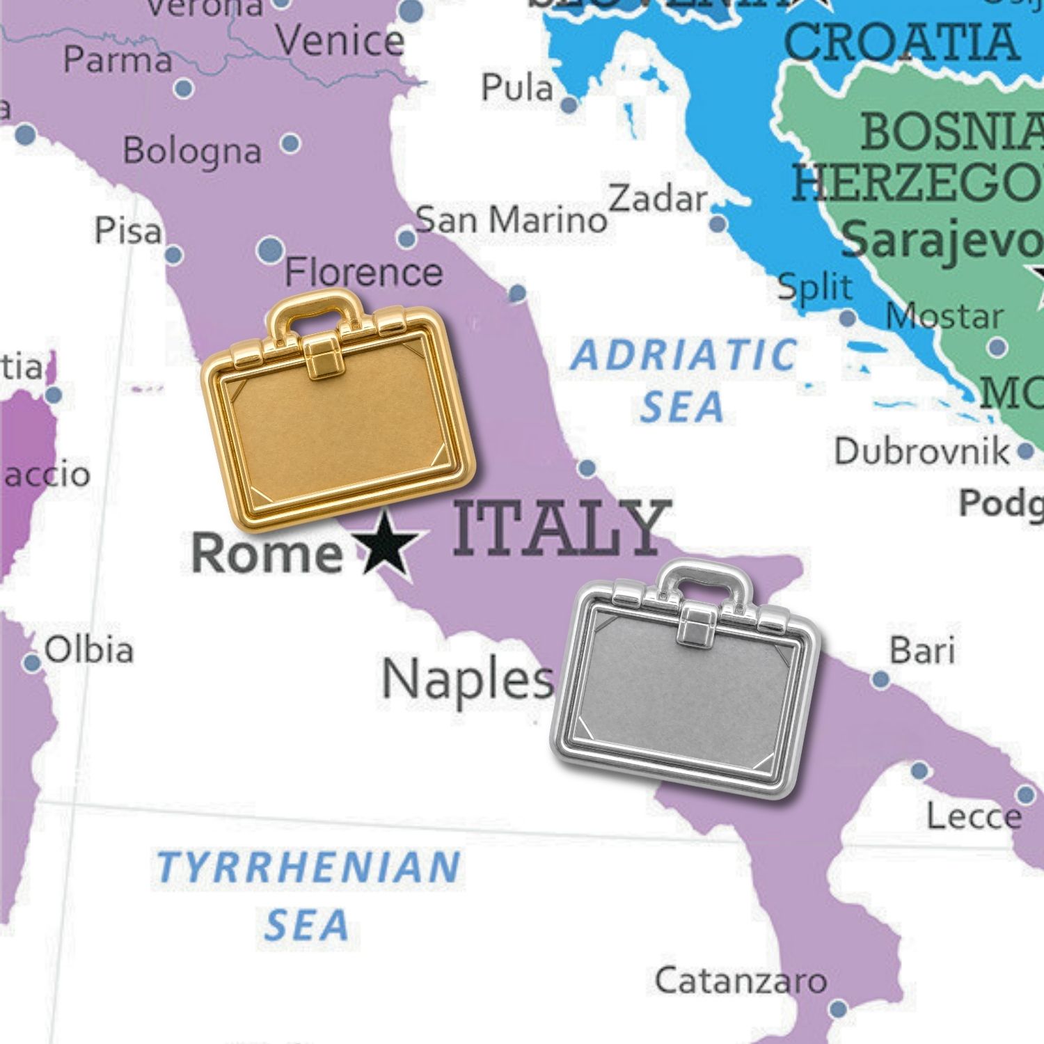 Gold and silver briefcase push pins displayed on colorful Italy map near Rome