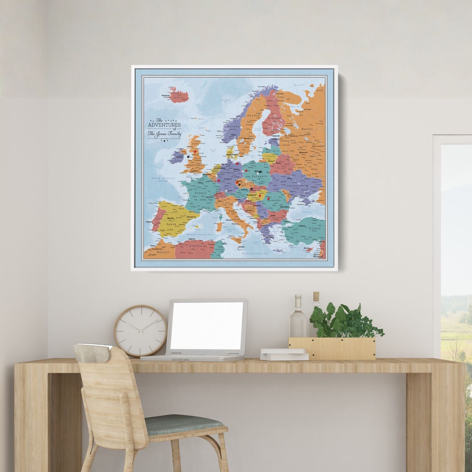 Personalized Blue Oceans Europe travel map with pins displayed in white frame above modern wooden desk