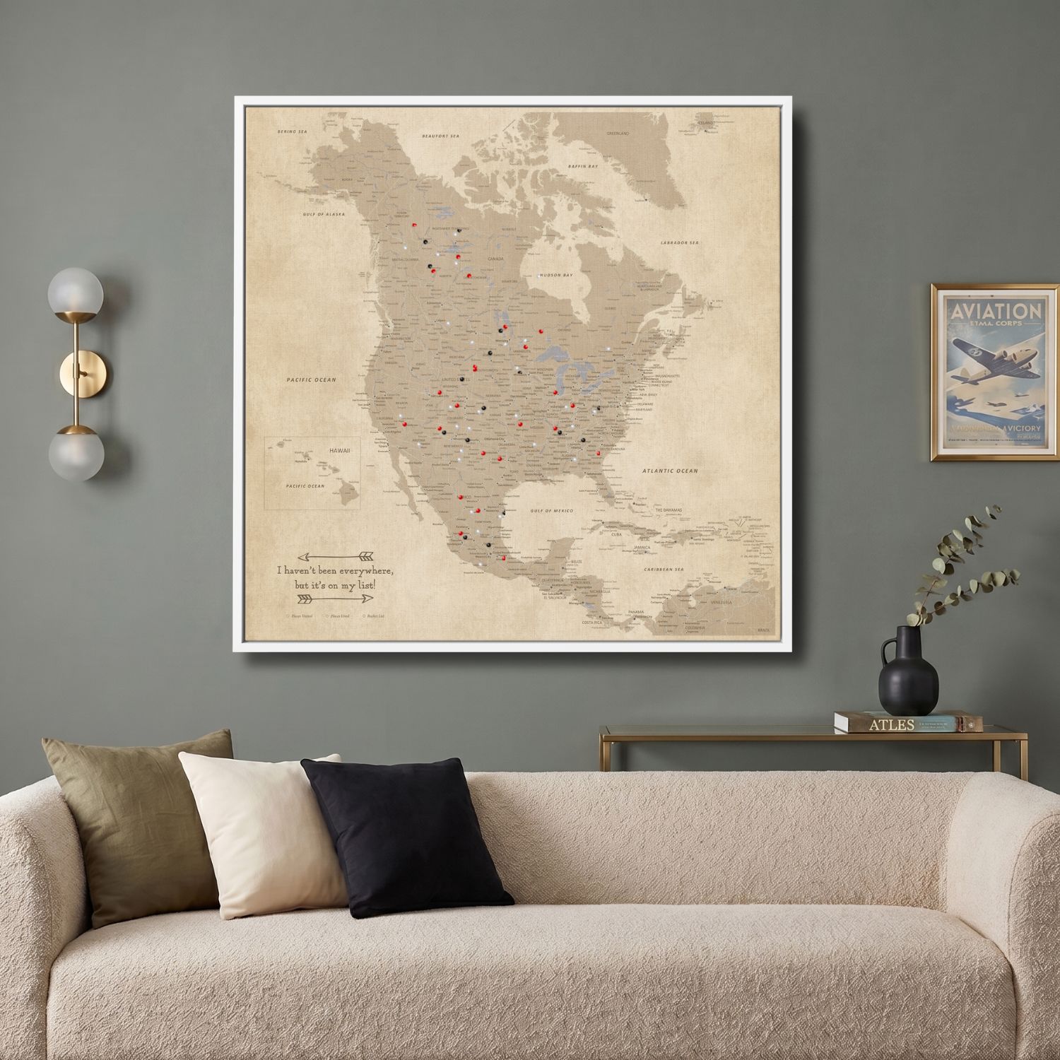 Vintage North America push pin travel map canvas hung above modern living room sofa