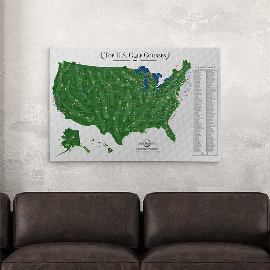 Top US Golf Courses canvas travel map with pins displayed above dark leather sofas